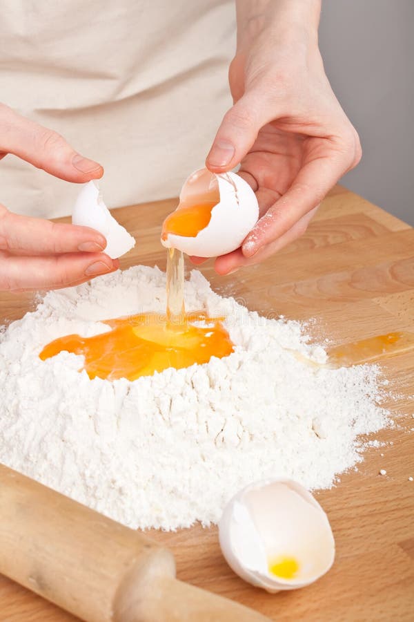 Man breaking egg on flour. stock photo. Image of face 85373190