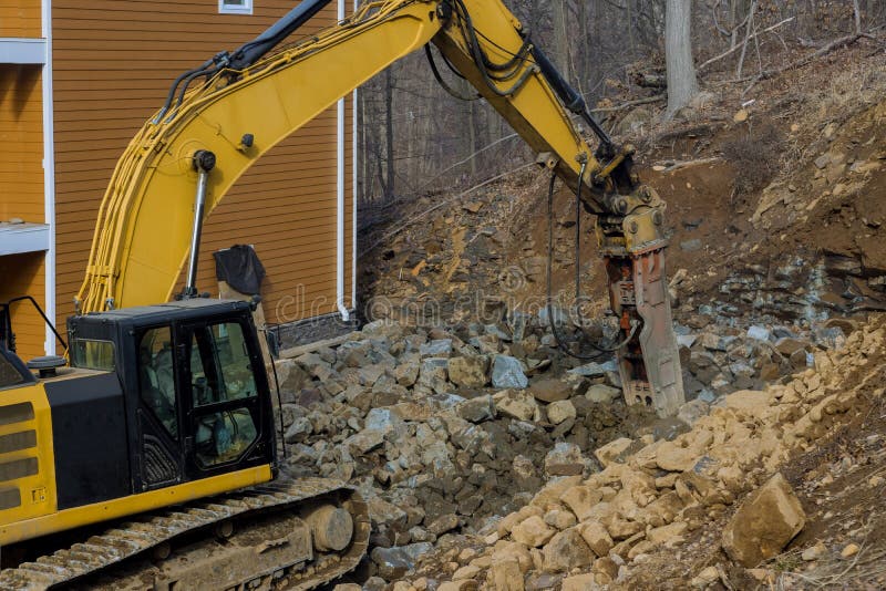 Breaking stone with machine drilling pneumatic hammer stock photos