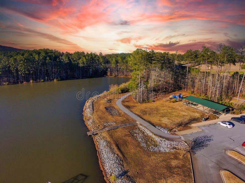 A breathtaking aerial shot of the still blue waters of Lake McIntosh at sunset