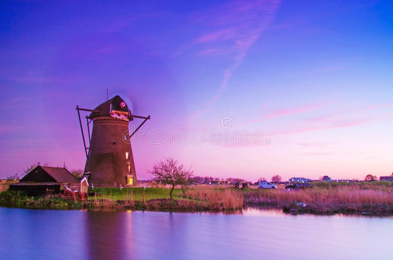 Breathtaking beautiful inspirational landscape with windmills in Kinderdijk, Netherlands at sunset. Fascinating places, tourist stock image Breathtaking beautiful inspirational landscape with windmills in Kinderdijk, Netherlands at sunset. Fascinating places, tourist stock image