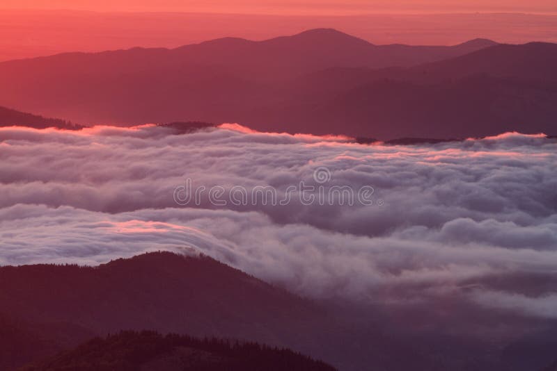 Breathtaking cloud sea at sunrise - dawn, Ceahlau Mountains, Romania