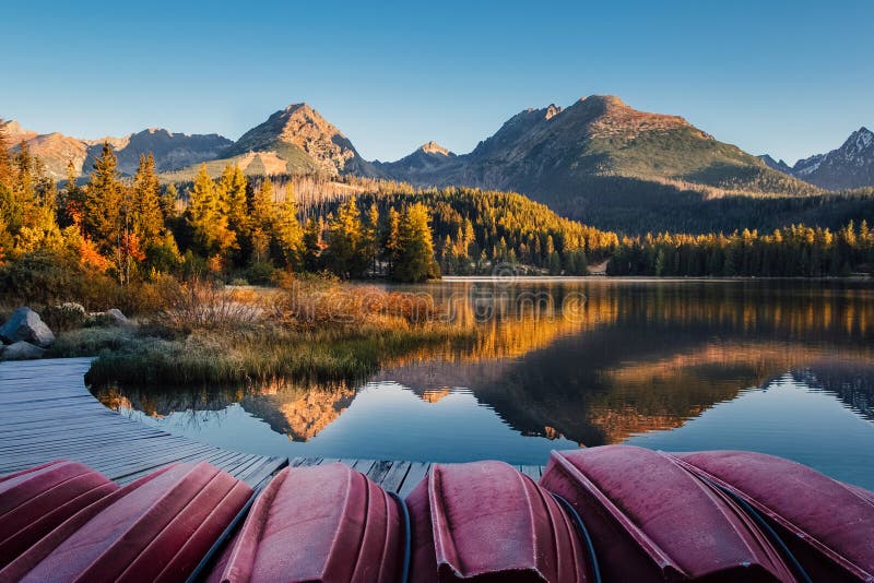 Autumn mountain lake with boat