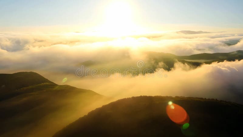 A breathtaking sunrise casts golden light over mountain peaks and clouds royalty free illustration