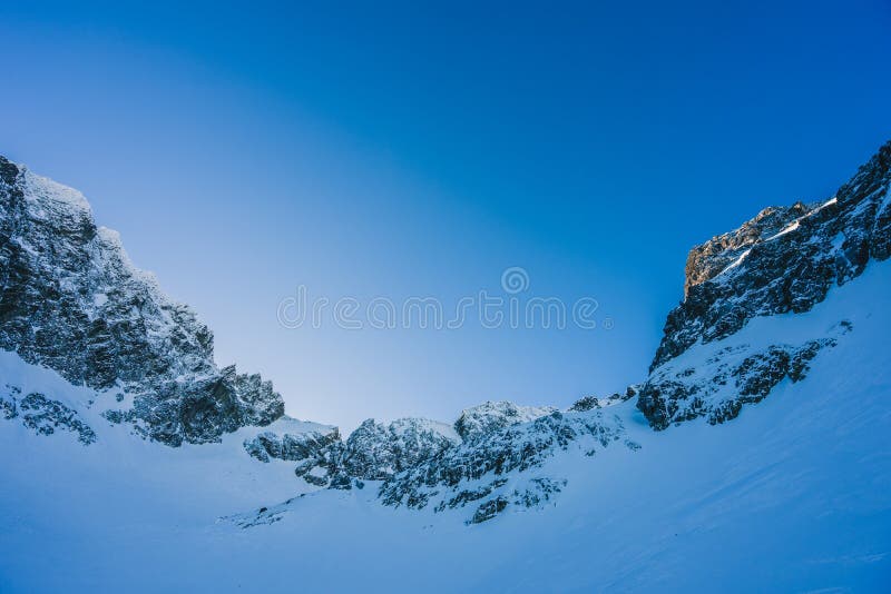 Breathtaking view of the magnificent mountains covered in snow under the blue sky in Slovakia