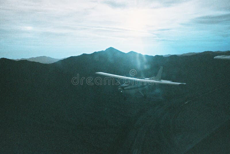 Breathtaking View of a White Airplane with Beautiful High Mountains and ...