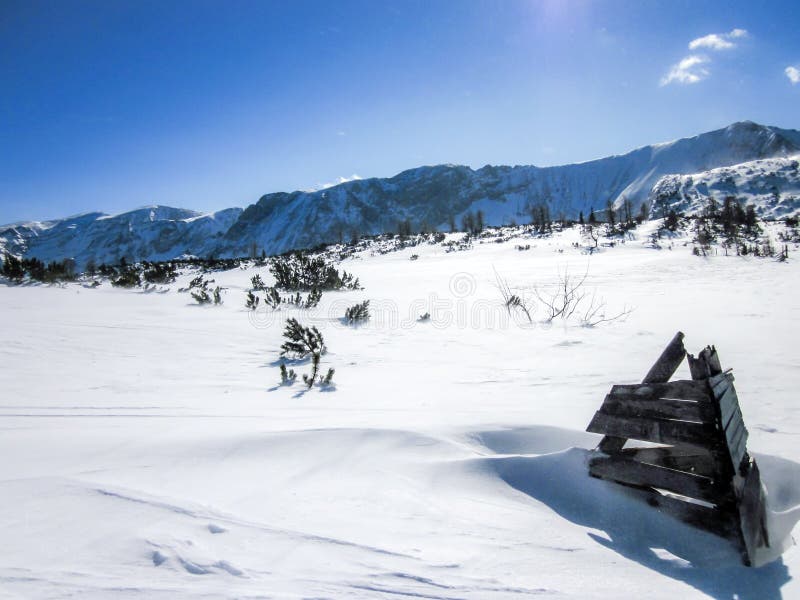 Breathtaking views of the Alpine mountains in Austria. Right holder wooden skis.