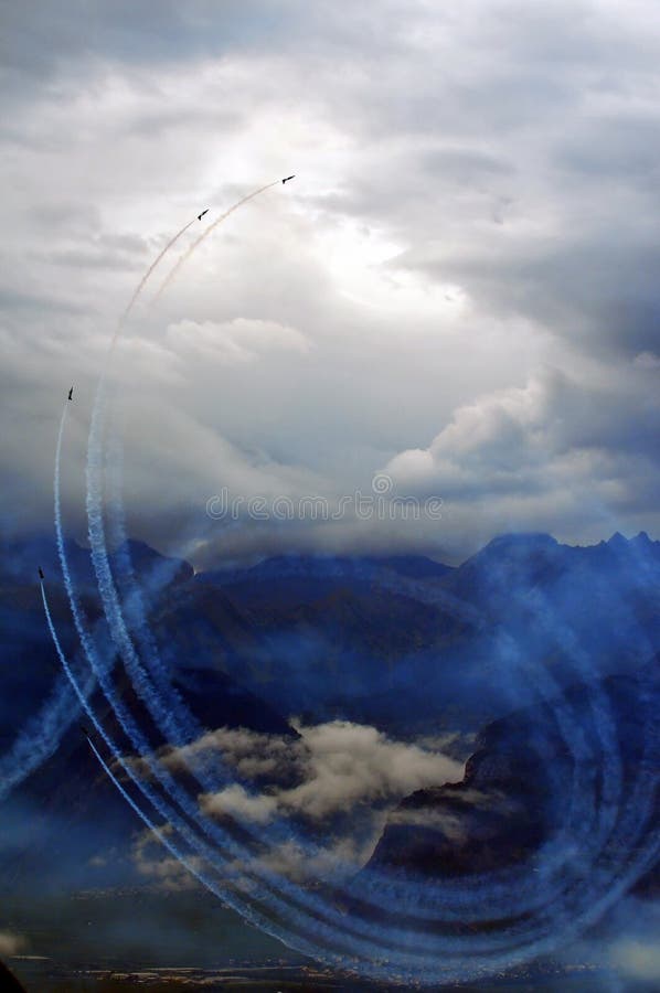 SION, SWITZERLAND - SEPTEMBER 17: Breitling jet team performing large loop with smoke at the Breitling Air show. September 17, 2011 in Sion, Switzerland. SION, SWITZERLAND - SEPTEMBER 17: Breitling jet team performing large loop with smoke at the Breitling Air show. September 17, 2011 in Sion, Switzerland