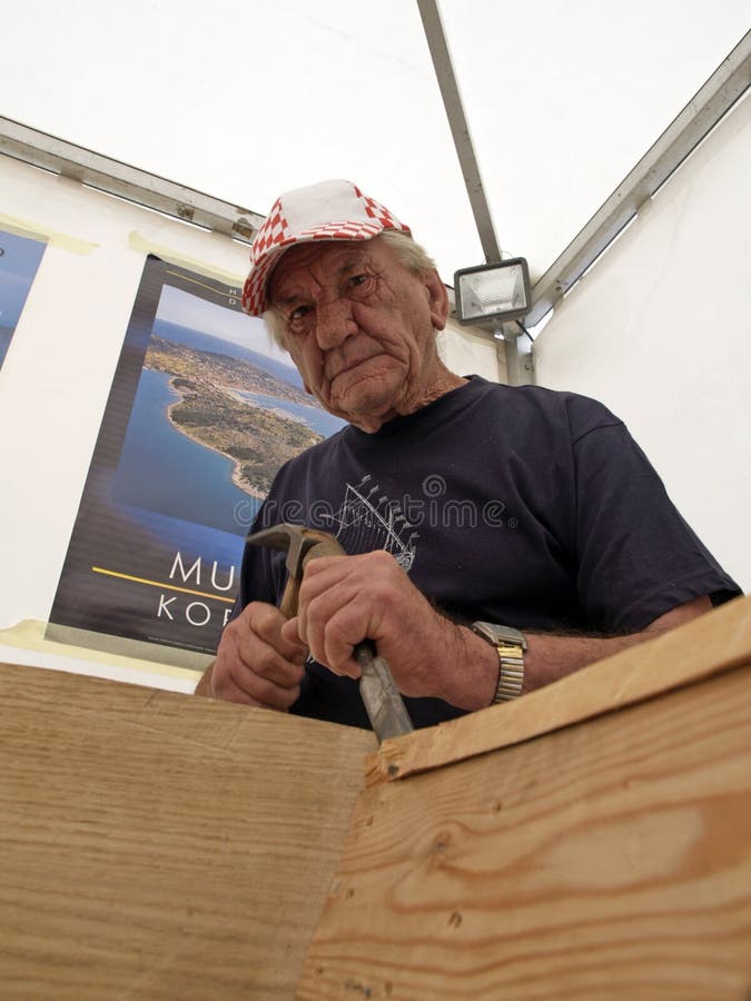Carpenter works with a chisel on the restoration of an old wooden boat stock photos Carpenter works with a chisel on the restoration of an old wooden boat stock photos