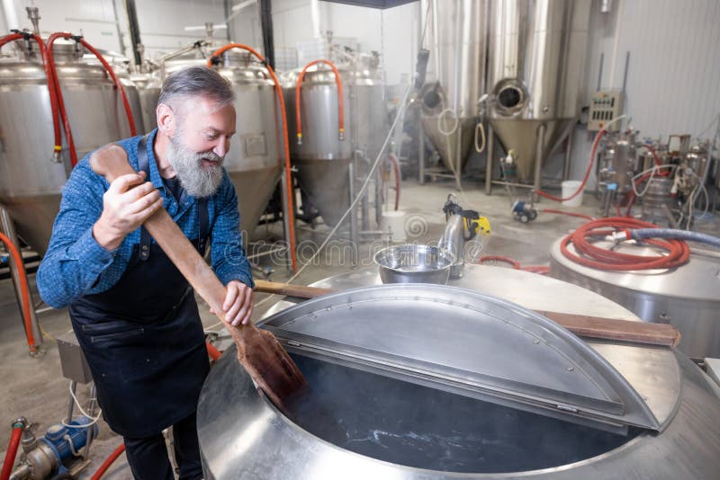 Brewery Worker Stirring Fresh Beer in a Tank Stock Image Image of