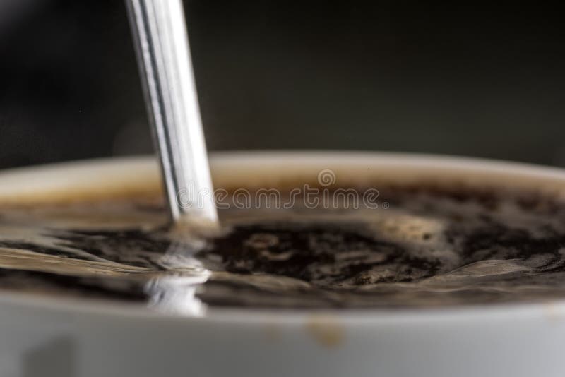 Brewing Boiling Water Instant Coffee in a Mug Closeup Stock Photo