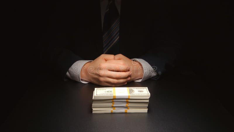 BRIBE: Businessman waits and puts a heap money on a table