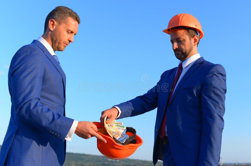 Bribery and business bargain concept. Architects with serious faces stock photo Bribery and business bargain concept. Architects with serious faces stock photo