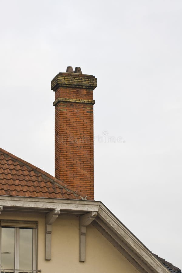 Brick chimney on tiled roof