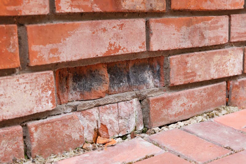 Brick, defectived,cracked in brickwork. Destruction of red bricks due to improper firing. Concept of material selection for the c stock photo