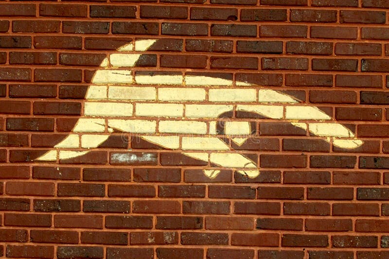 Finger pointing down painted on a brick wall. Finger point down stock images, royalty-free photos and pictures