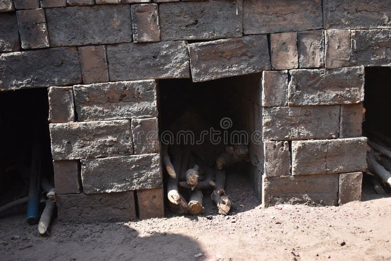 Brick Kiln.Brick Making Process .a Burning Traditional Indian Clove Clamp Kiln with Raw Bricks