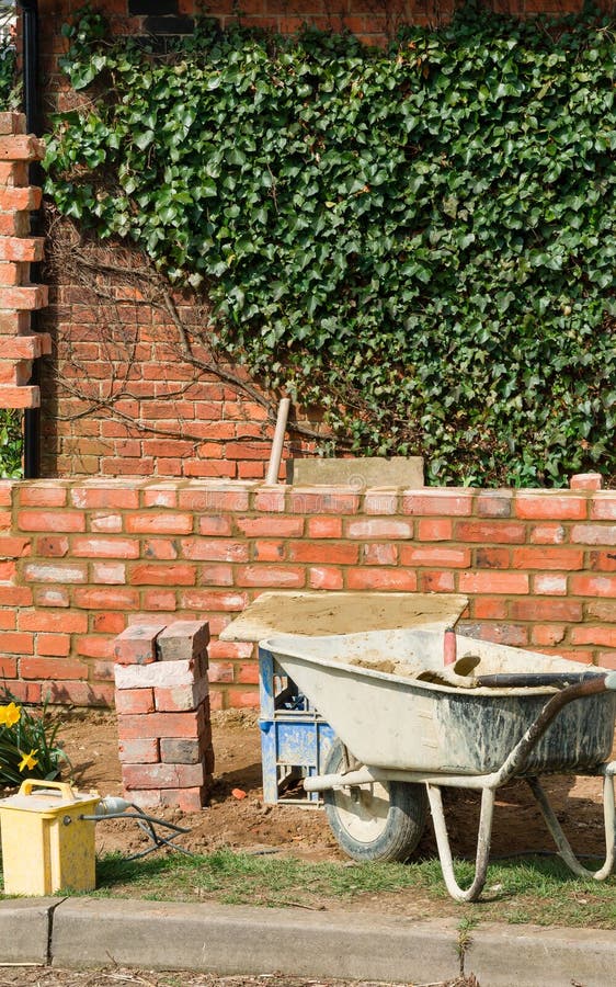 Brick laying, building a brick garden wall, UK. Brick laying, building a red brick garden wall in the UK royalty free stock image Brick laying, building a brick garden wall, UK. Brick laying, building a red brick garden wall in the UK royalty free stock image