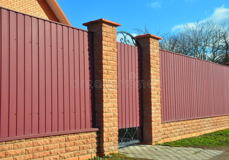 Brick and Metal Fence with Door and Gate. Fencing construction.