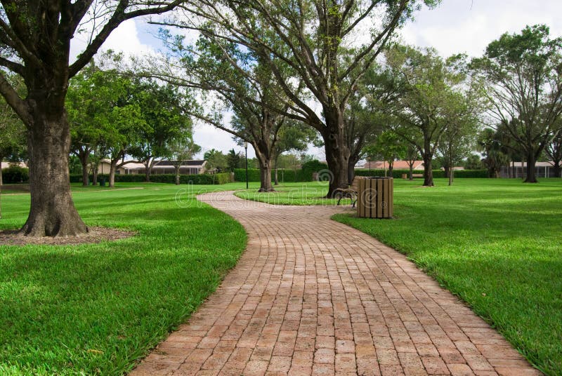 A brick path in the park long