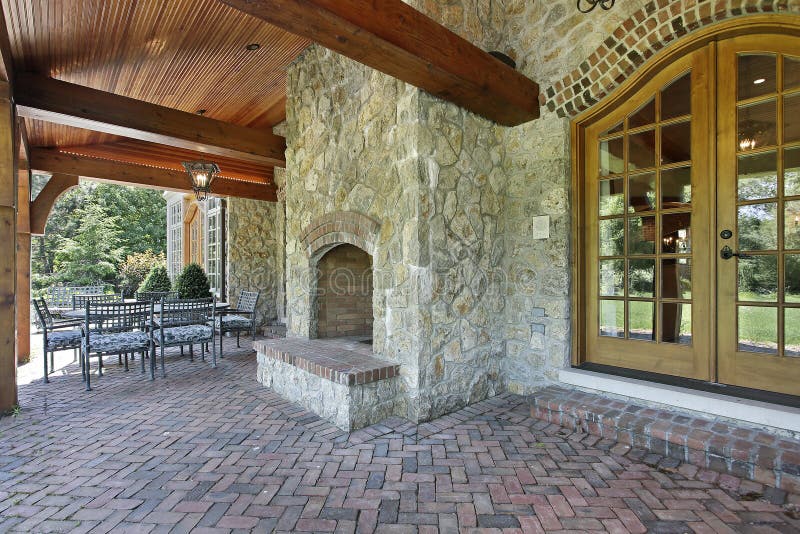 Brick patio with stone fireplace