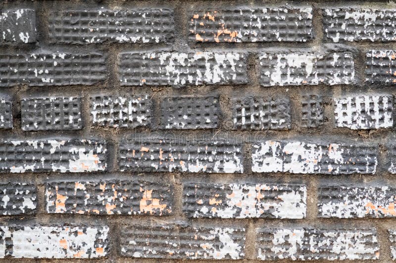 Brick Wall Covered with Several Layers of Peeling Paint of Different