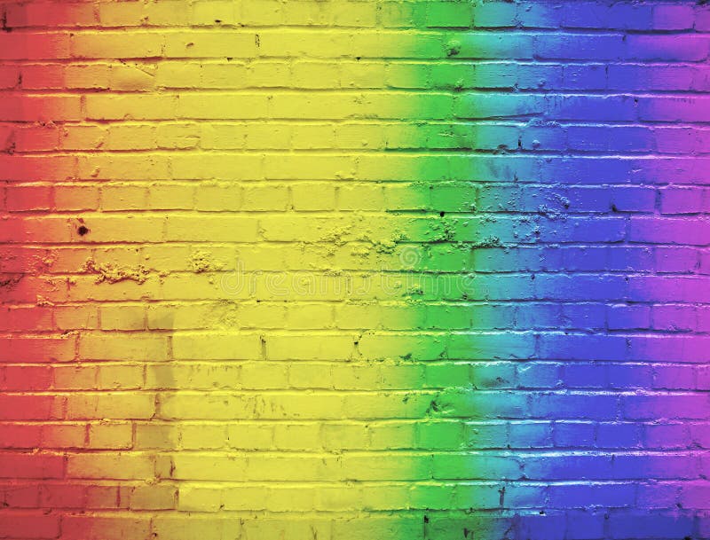 A brick wall painted in a rainbow color all color