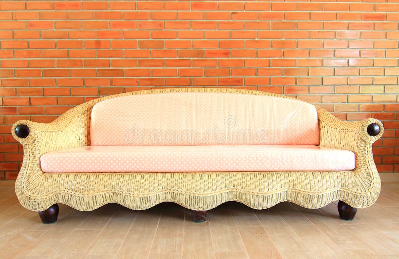 Brick wall with a Rattan sofa