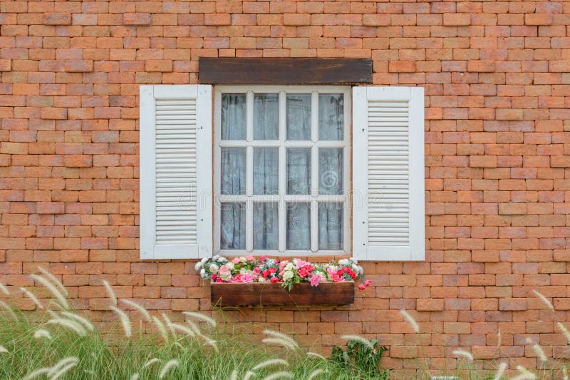 Brick wall with window stock photo. Image of bush, glass 43551678