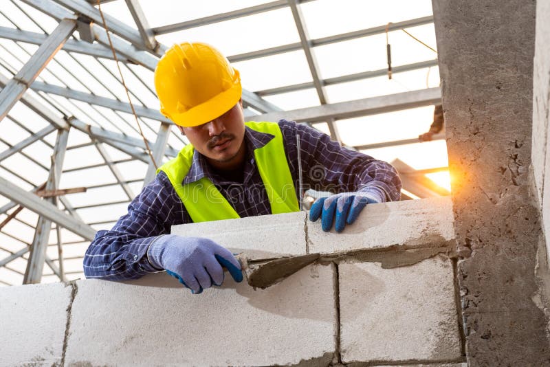 Bricklayer Builder Working with Autoclaved Aerated Concrete Blocks