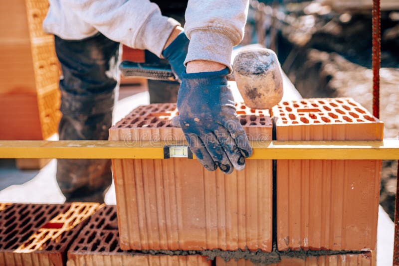 Bricklayer Industrial Worker Installing Brick Masonry on Exterior Wall