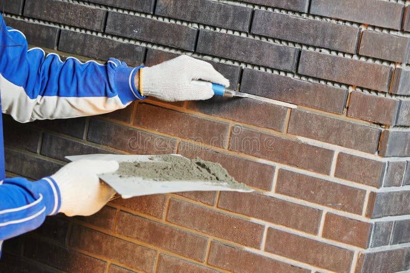 Construction Process of bricklaying Using the Brick Jointer Trowel. Bricklayer tiler stock images, royalty-free photos and pictures