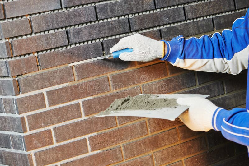 Construction Process of bricklaying Using the Brick Jointer Trowel. Bricklayer tiler stock images, royalty-free photos and pictures