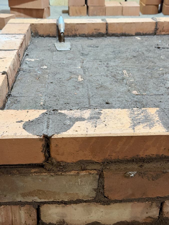 Brickwork of the foundation during the construction of a heating stove. Load structural stock images, royalty-free photos and pictures