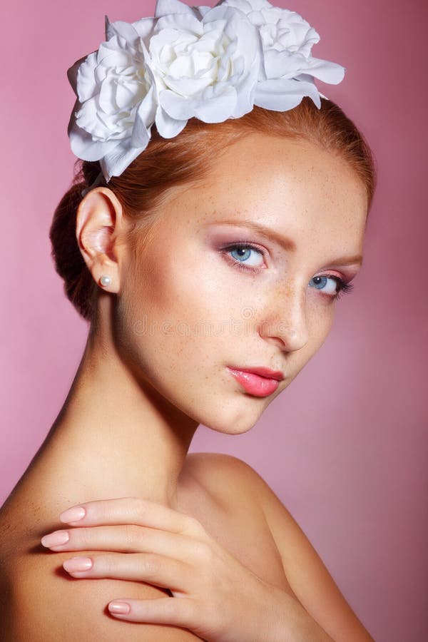 Bridal Beauty .Beautiful young woman with professional make up ..Bride s portrait on a pink background.