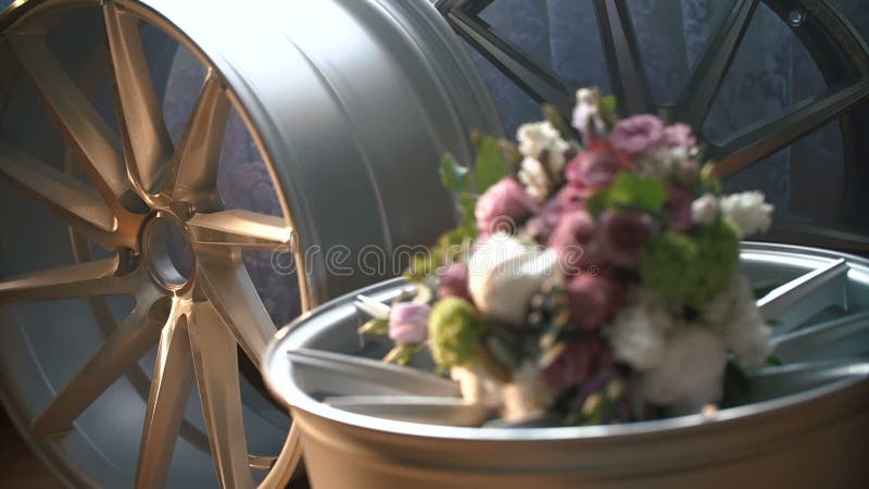 Bridal bouquet on the car wheel stock video