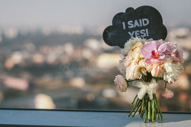 Bridal bouquet with I Said Yes sign