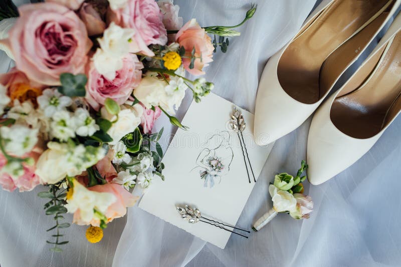 Bridal bouquet, invite list and bride shoes