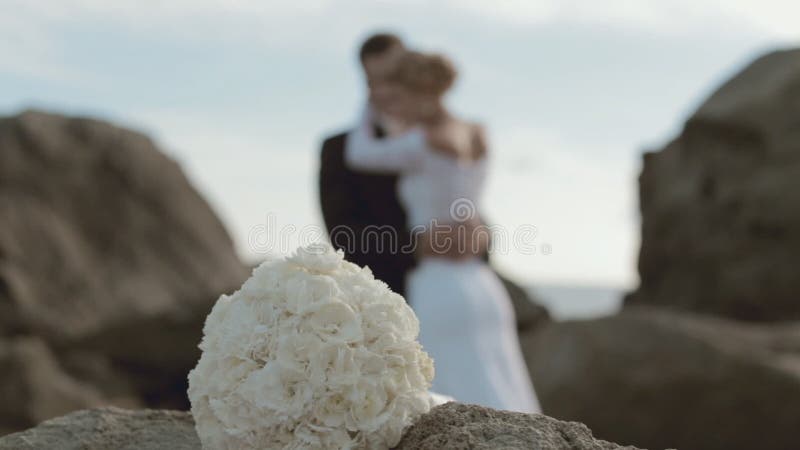 Bridal bouquet and newlyweds in love out of a stock video footage