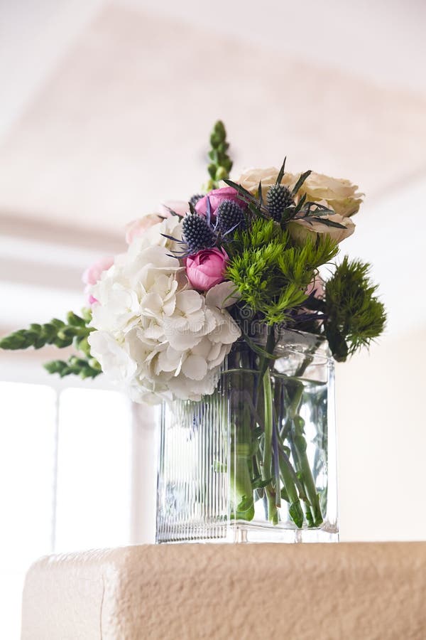 Bridal Bouquet in Vase on the Table in the Morning on a Wedding Day
