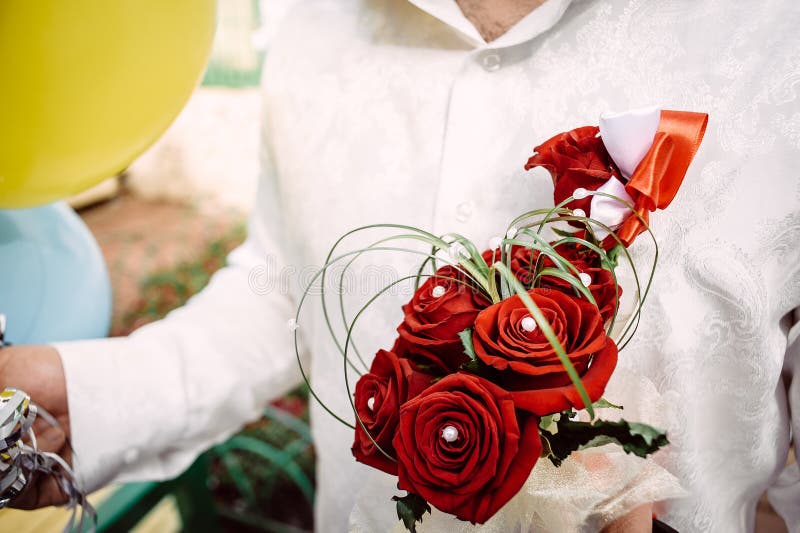 Bridal bukiet czerwone róże w rękach fornal obraz stock Bridal bukiet czerwone róże w rękach fornal obraz stock