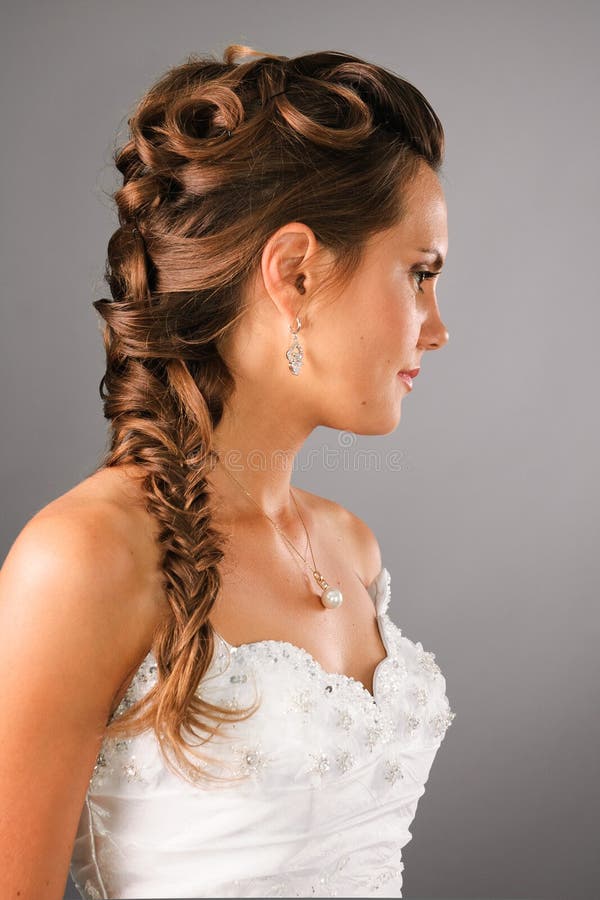 Bridal hairdo with a plate on studio neutral background. Bridal hairdo with a plate on studio neutral background