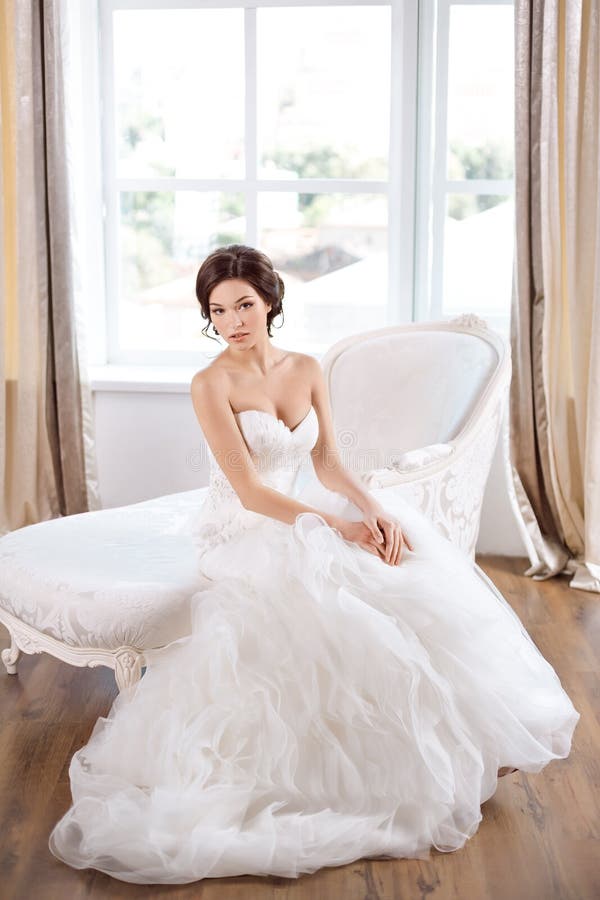 Bride In Beautiful Dress Sitting On Chair Indoors Stock 