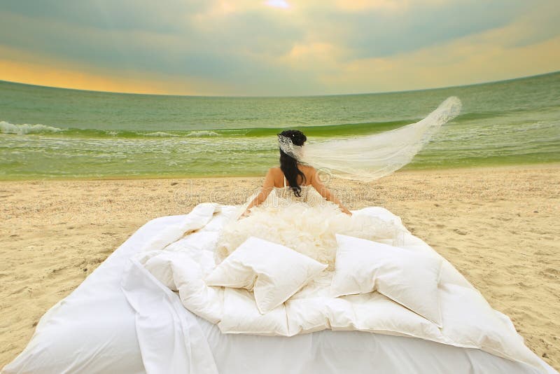 Bride in bed at the coastline.