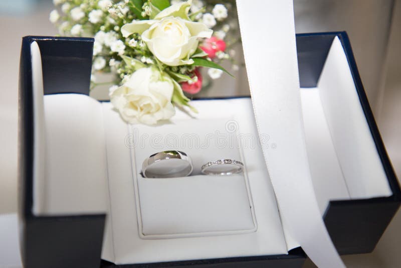 Bride Bouquet of White Roses and Wedding Rings in a Box Stock Image