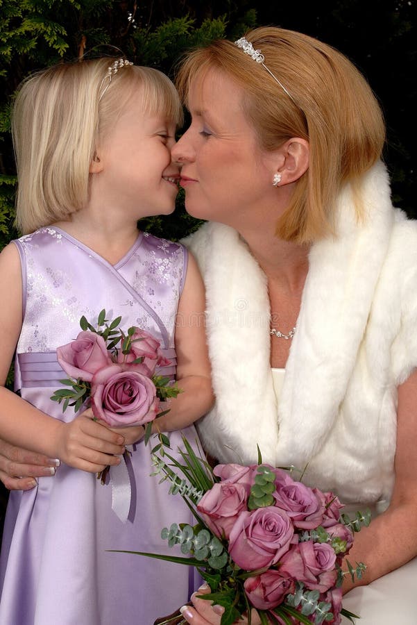 A Bride and Bridesmaid sharing a tender moment on a wedding day