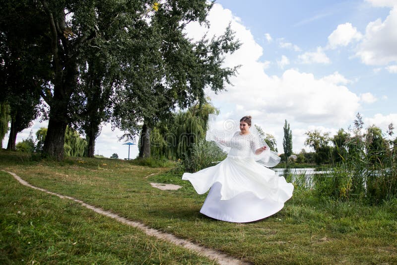 Bride dancing in park royalty free stock photo Bride dancing in park royalty free stock photo