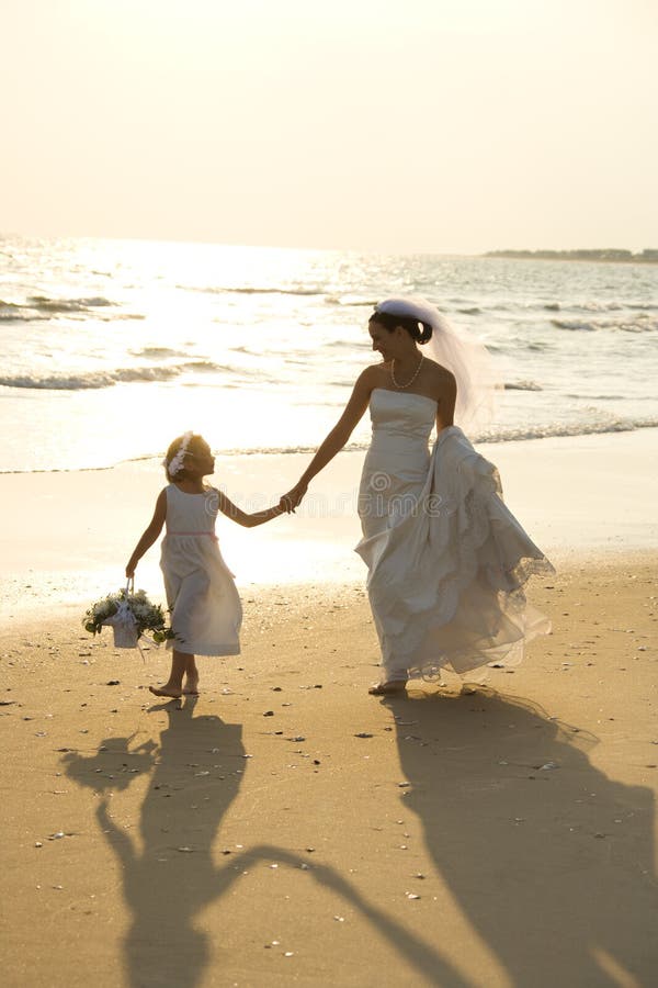 Bride and flower girl walking royalty free stock photo