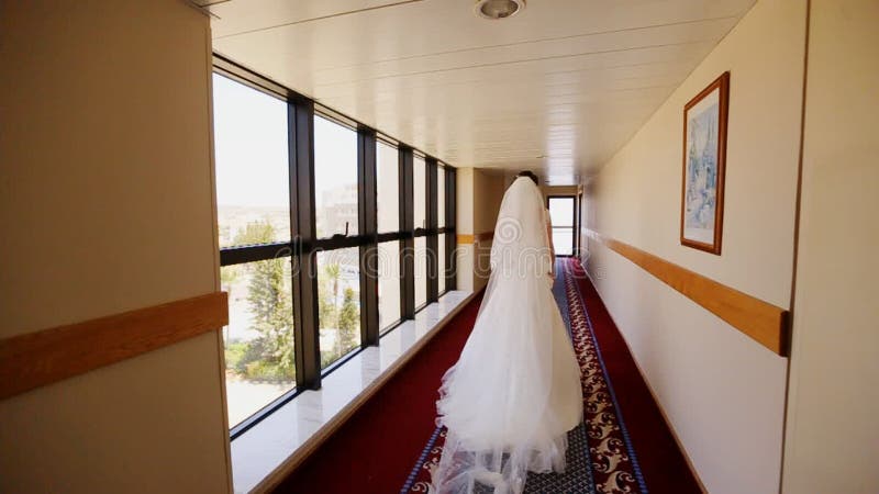 Bride goes corridor overlooking the sea