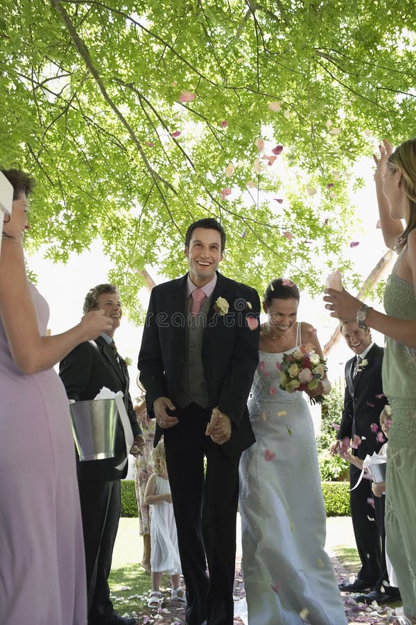 Bride and Groom Being Showered with Flower Petals Stock Photo Image