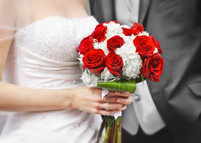 Bride and groom holding bridal bouquet close up. Bride and groom holding bridal bouquet close up